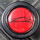 ” MOMO NIKI LAUDA RED HORN BUTTON”/